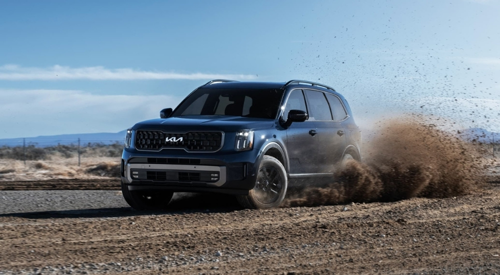 A blue 2023 Kia Telluride is shown from the front at an angle.