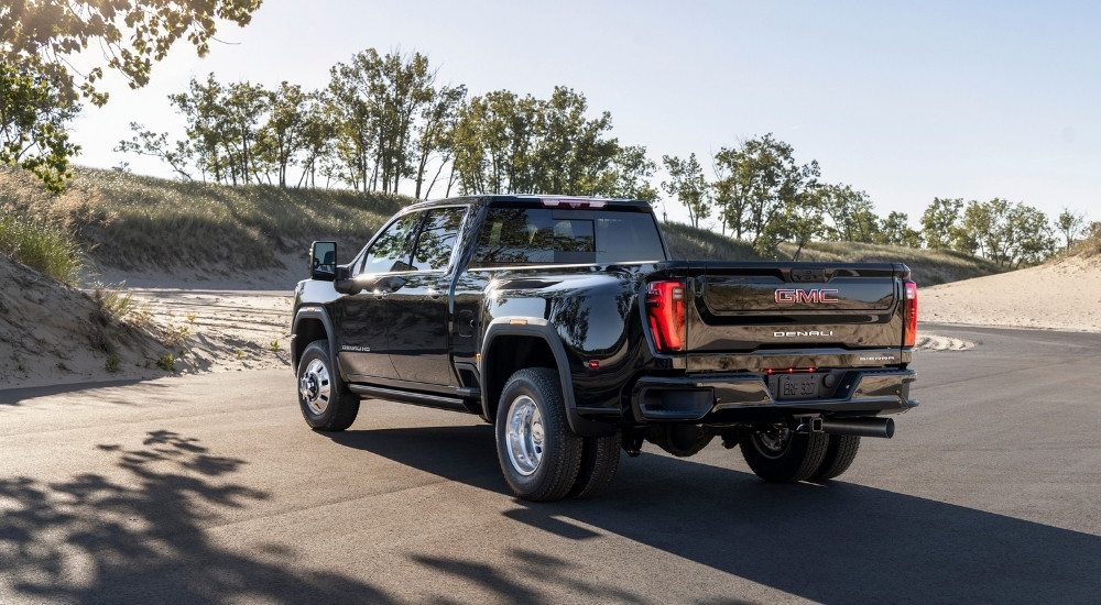 A black 2024 GMC Sierra 3500 HD Denali is shown from the rear.