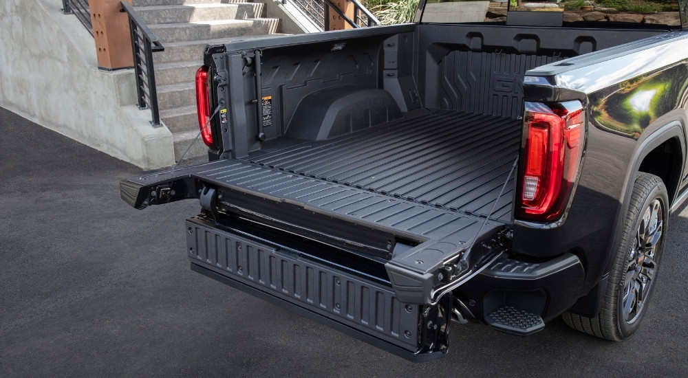 A popular feature on GMC trucks for sale, the MultiPro Tailgate on a black 2024 GMC Sierra 1500 Denali Ultimate.