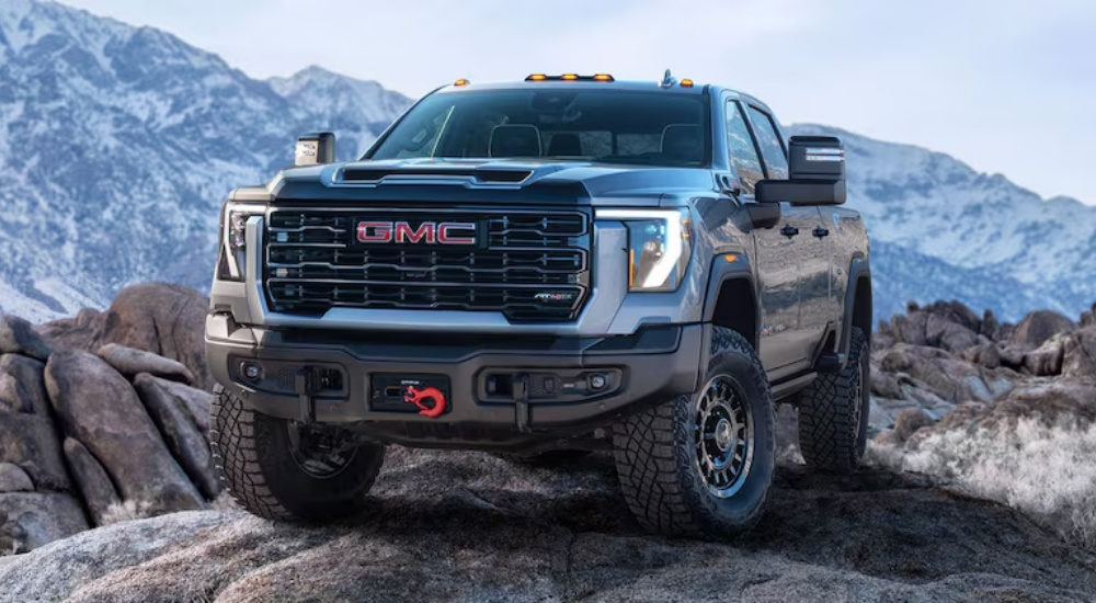 A gray 2024 GMC Sierra 2500 AT4X is shown parked on a mountain.