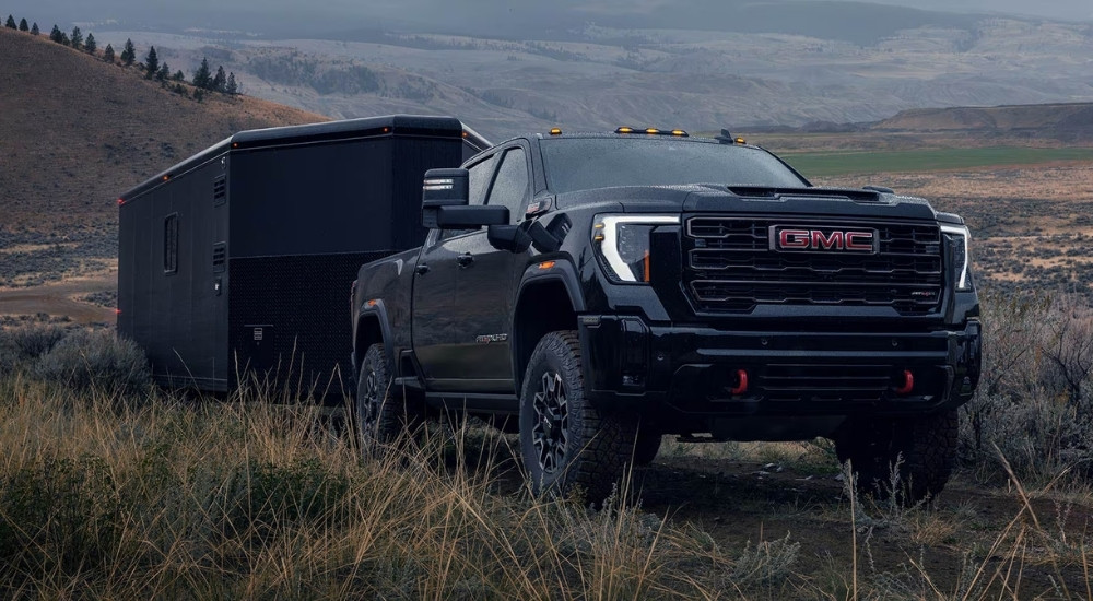 Black 2026 GMC Sierra 2500 HD AT4X towing a trailer