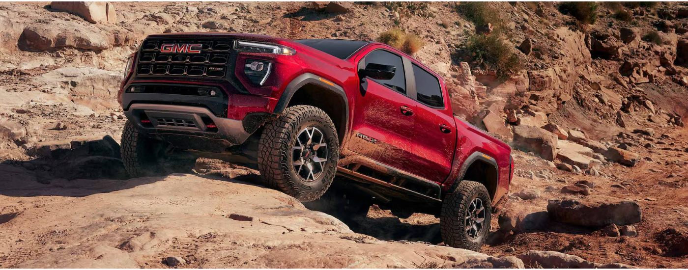 Red 2026 GMC Canyon AT4X parked on a rock