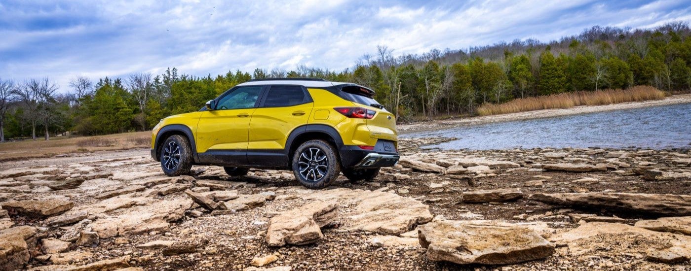 A yellow 2024 Chevy Trailblazer ACTIV is shown parked near a tent.