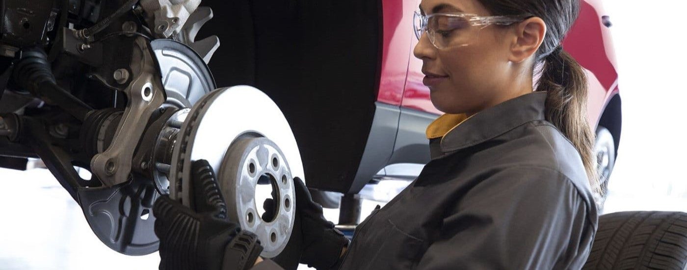 A Chevy technician is shown removing a rotor during a service appointment.