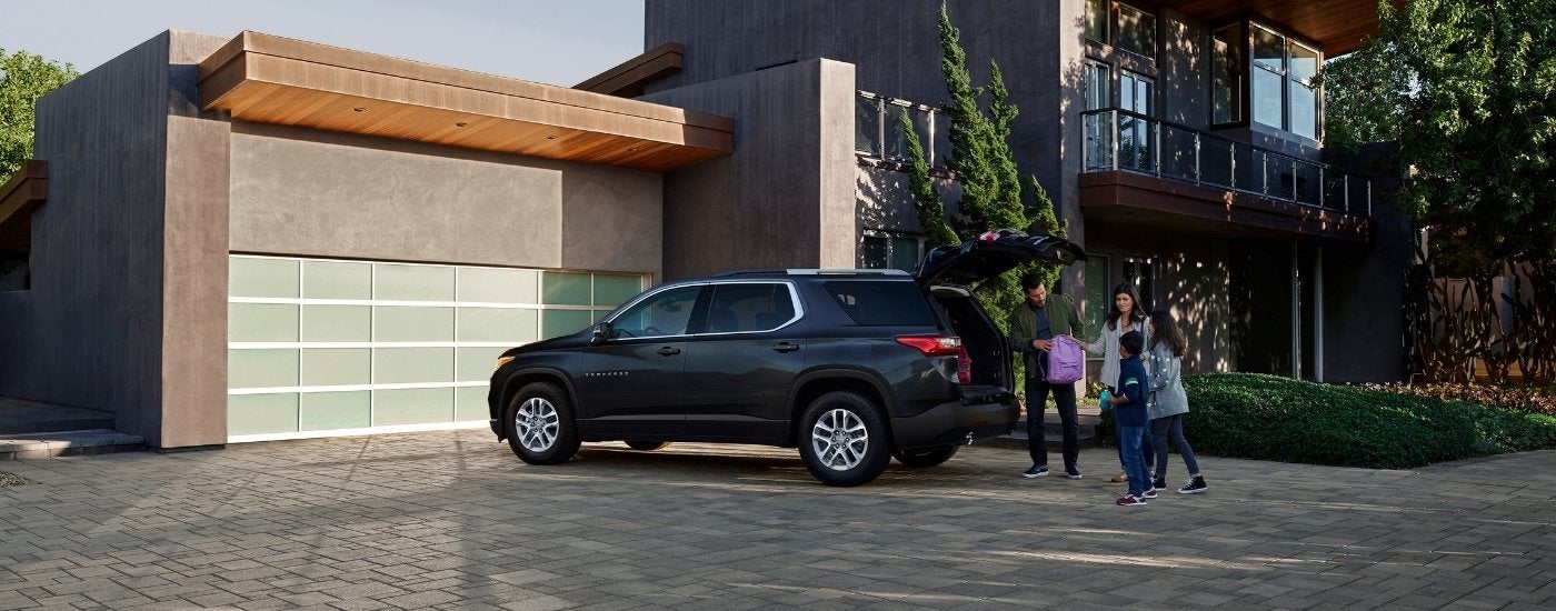 A dark blue 2019 Chevy Traverse is shown parked on a driveway.