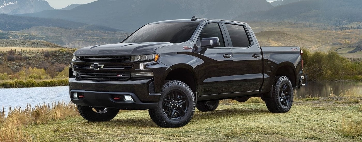 A black 2021 Chevy Silverado 1500 Z71 Trail Boss is shown parked on grass.