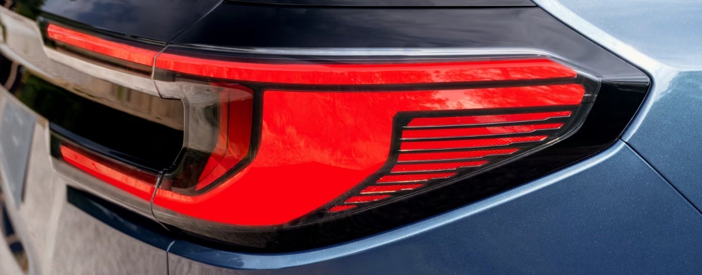 Passenger side tailight on a blue 2025 GMC Acadia Denali.