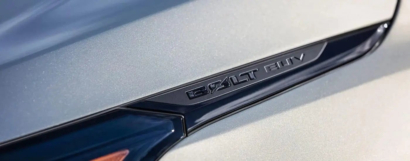 A close up shows a headlight logo on a silver 2023 Chevy Bolt EUV after leaving a Germantown Chevy dealer.