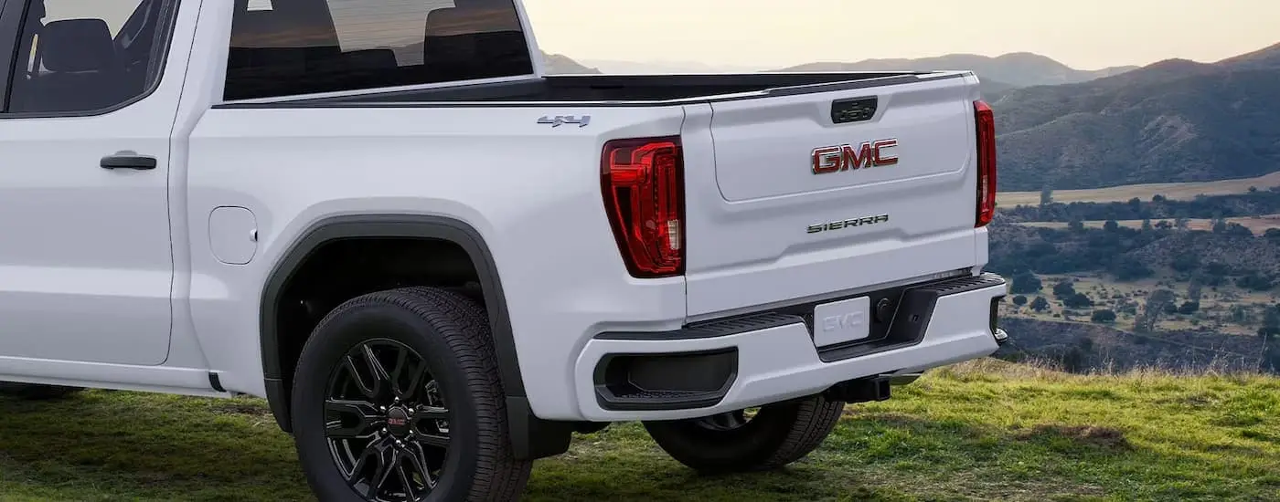 The tailgate on a white 2024 GMC Sierra 1500 SLE is shown.