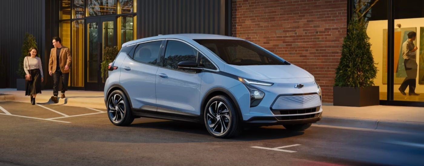 A light blue 2022 Chevy Bolt EV is parked on a city street after leaving a Tennessee Chevy dealer.