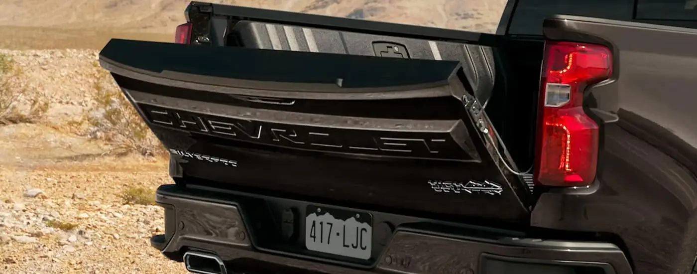 A close up of the tailgate on a black 2022 Chevy Silverado 1500 Limited High Country is shown.