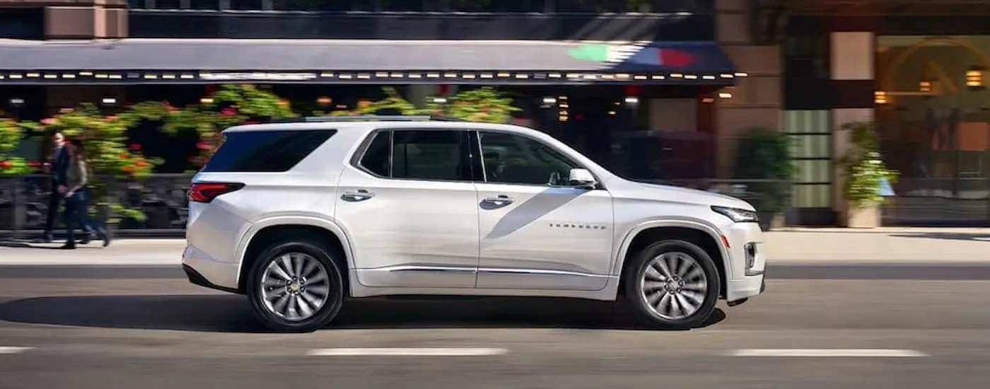 A white 2023 Chevy Traverse is shown from the side.