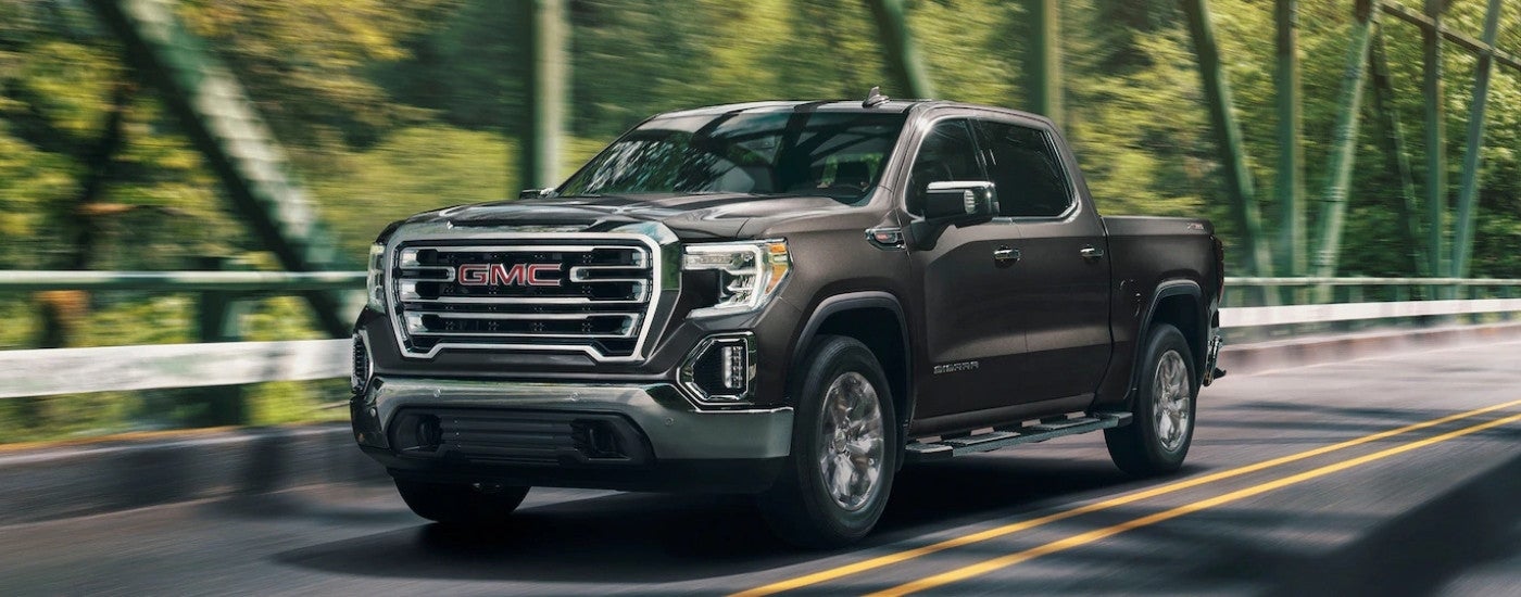 Grey 2019 GMC Sierra 1500 SLT driving over a bridge