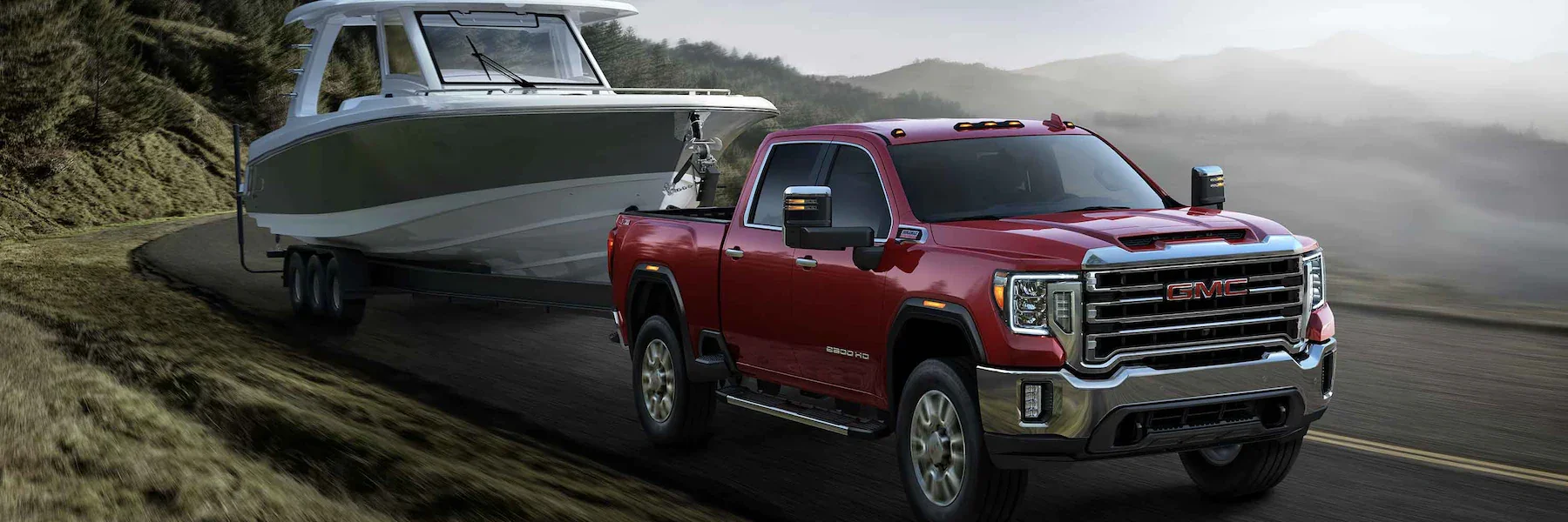 Red 2023 GMC Sierra 2500 HD towing a boat