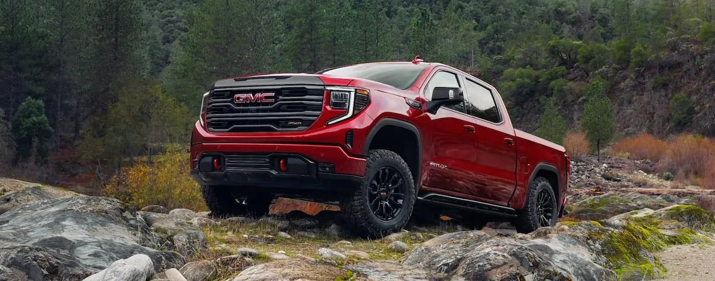 Red 2023 GMC Sierra 1500 AT4X parked off-road