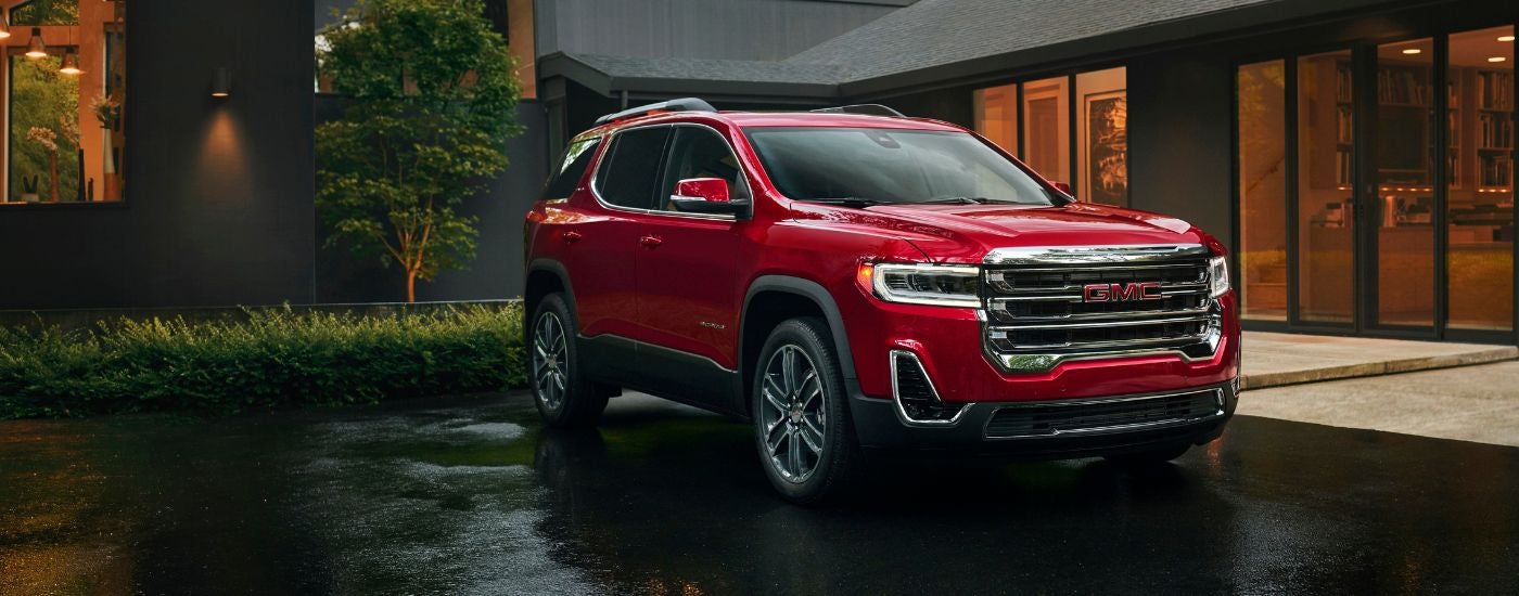 Red 2023 GMC Acadia parked on a driveway