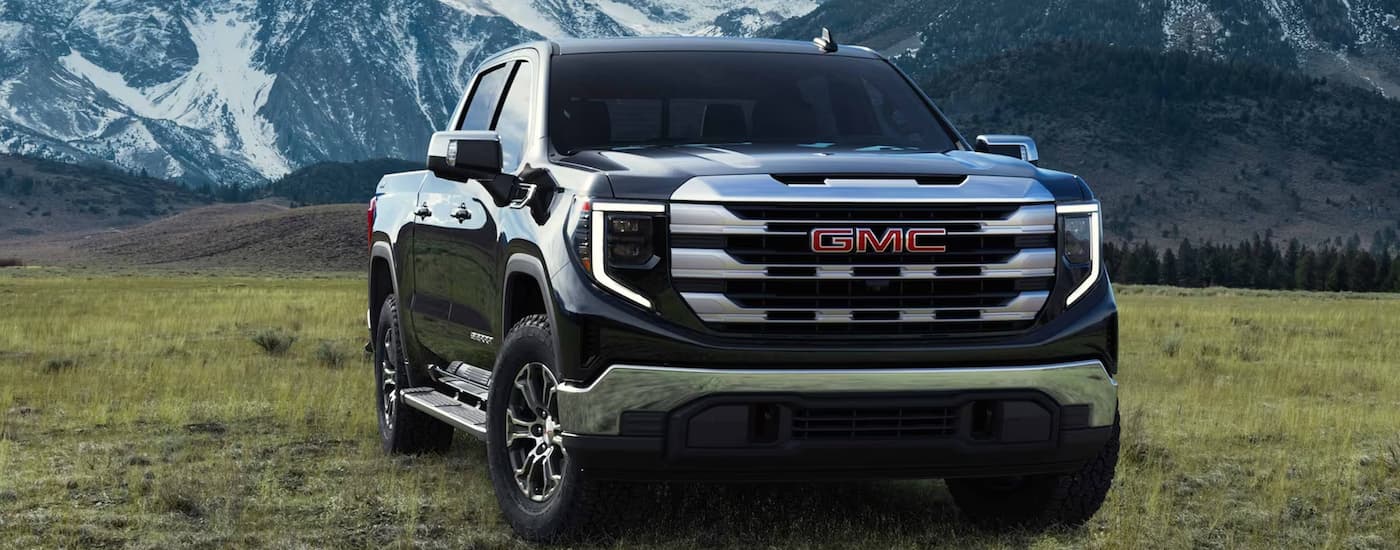 Black 2023 GMC Sierra 1500 parked on a field