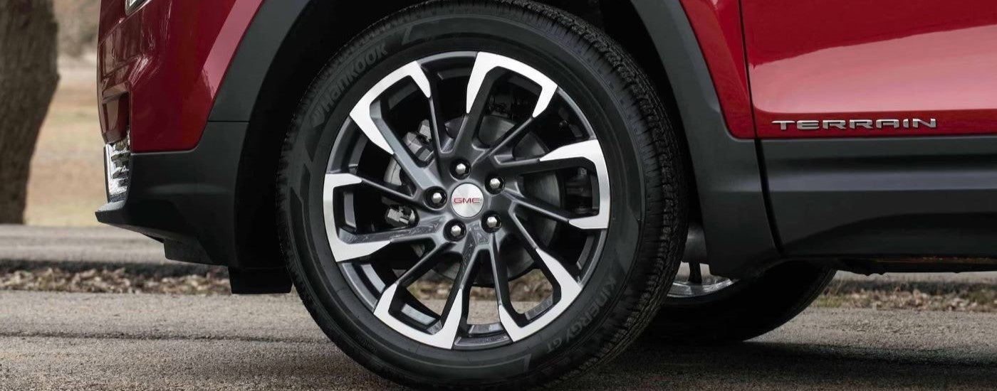 Front driver wheel on a red 2023 GMC Terrain SLT