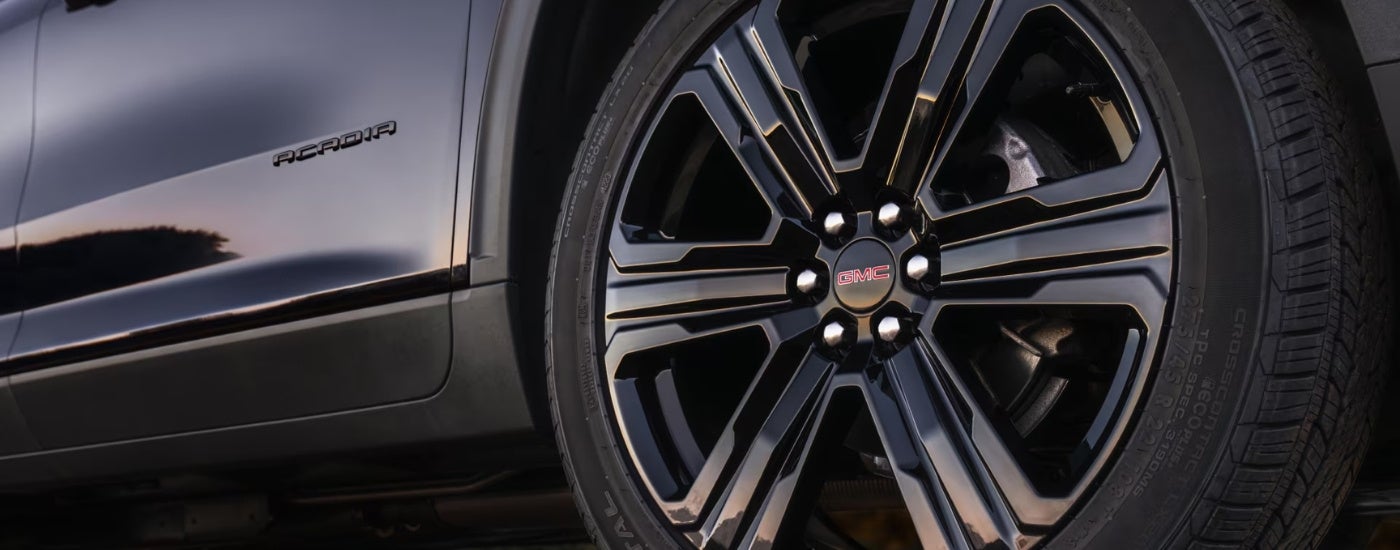 Wheel on a black 2025 GMC Acadia Elevation