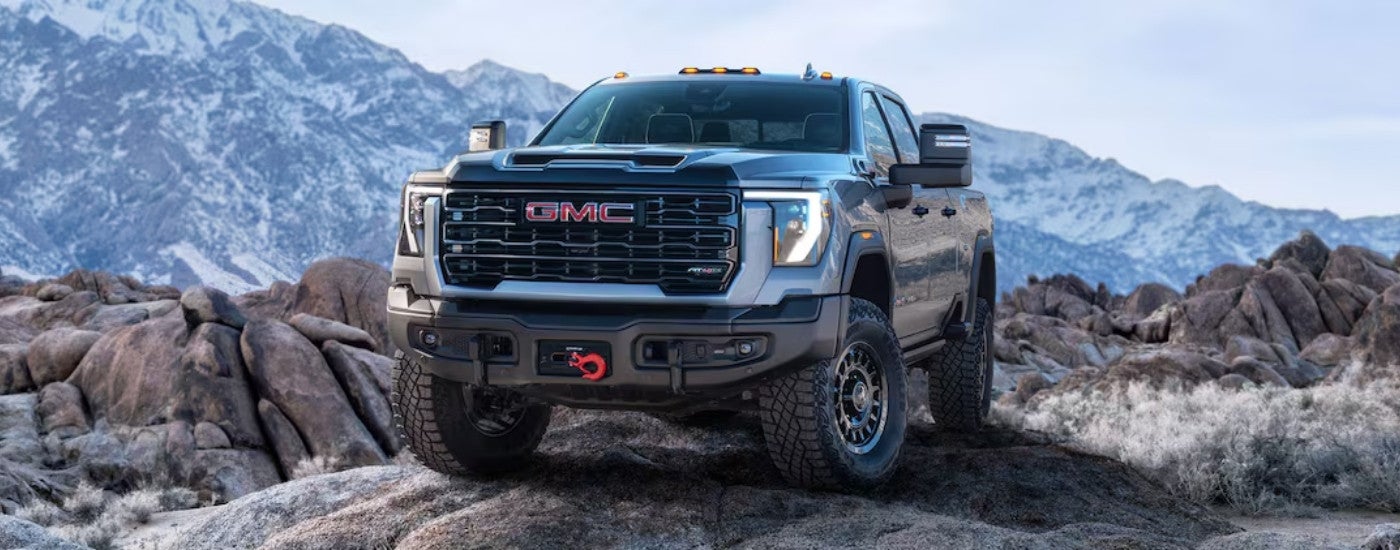 Silver 2025 Sierra 2500 HD AT4 AT4X AEV overlooking mountains
