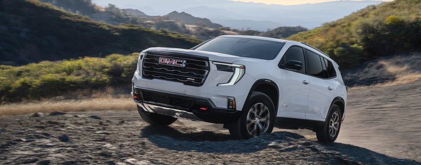 White 2026 GMC Acadia AT4 off-roading