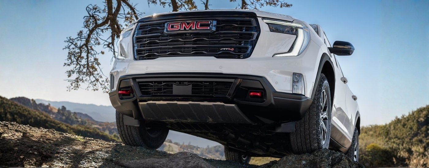 White 2026 GMC Acadia AT4 off-roading