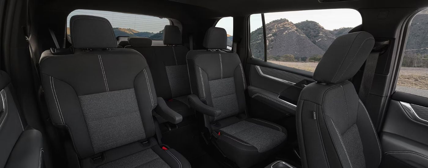 Black three-row interior of a 2026 GMC Acadia.