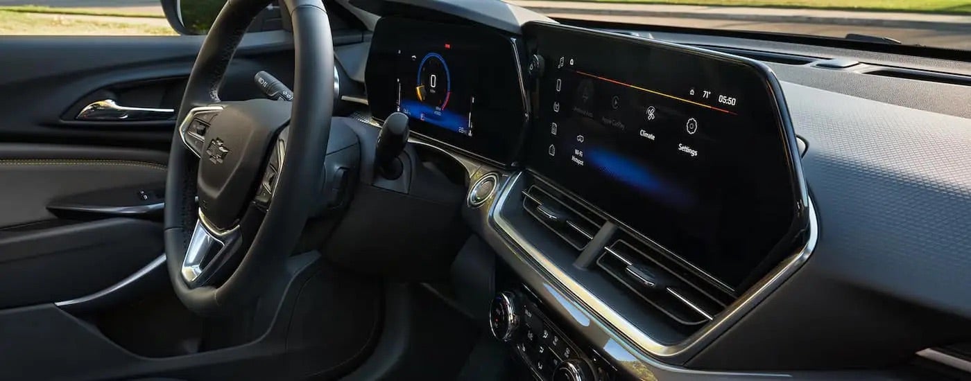 The steering wheel and digital dashboard displays in a 2025 Chevy Trax for sale.