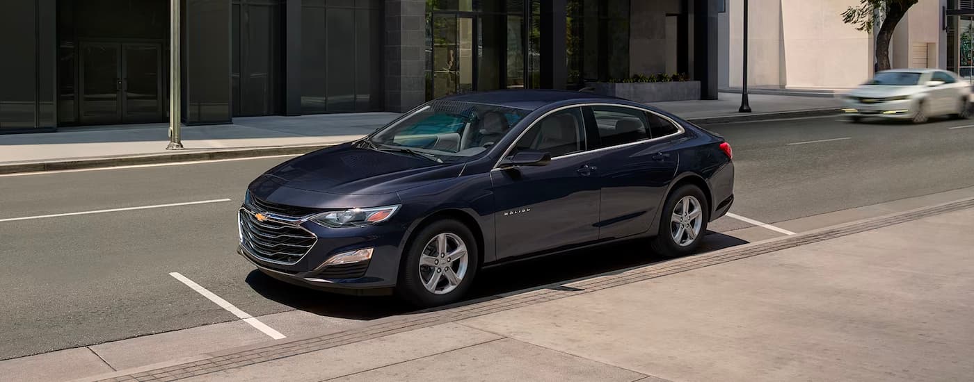 A blue 2024 Chevy Malibu is shown parked after visiting a Chevy dealer near Henderson.