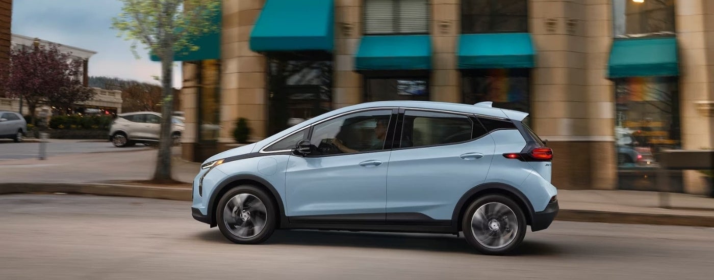 A light blue 2022 Chevy Bolt EV is shown on a city street after leaving a Chevy dealer in Olive Branch, MS.