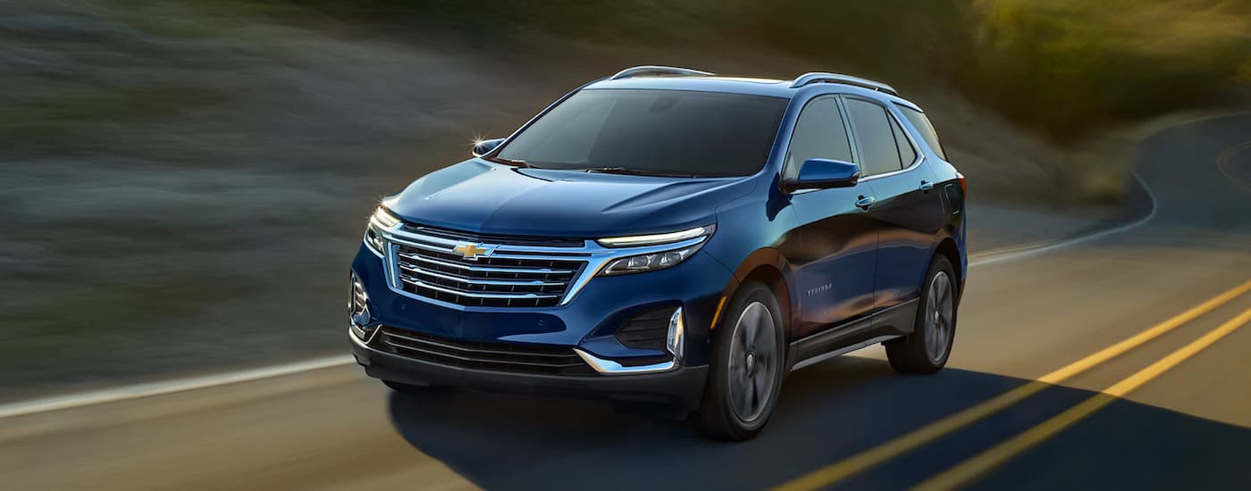 A blue 2022 Chevy Equinox driving on an open road.