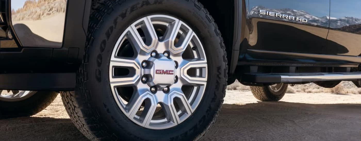 Close-up of the wheel on a black 2025 GMC Sierra 2500 HD.