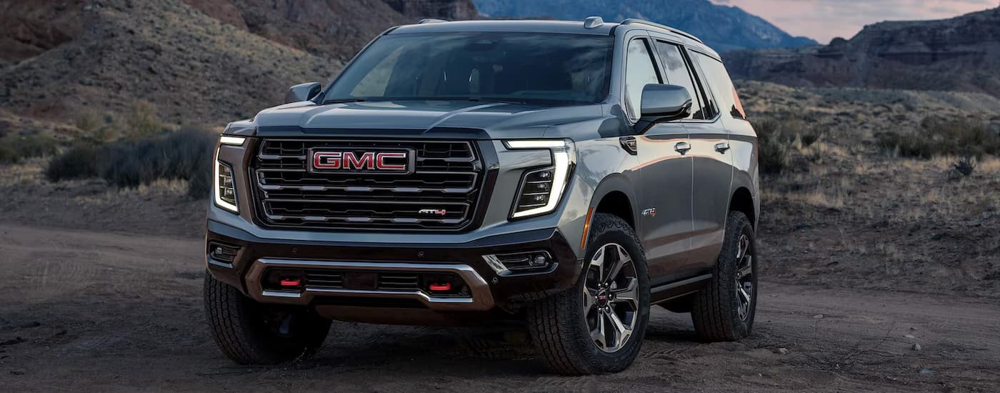 Grey 2025 GMC Yukon for sale in Corinth parked on rocks