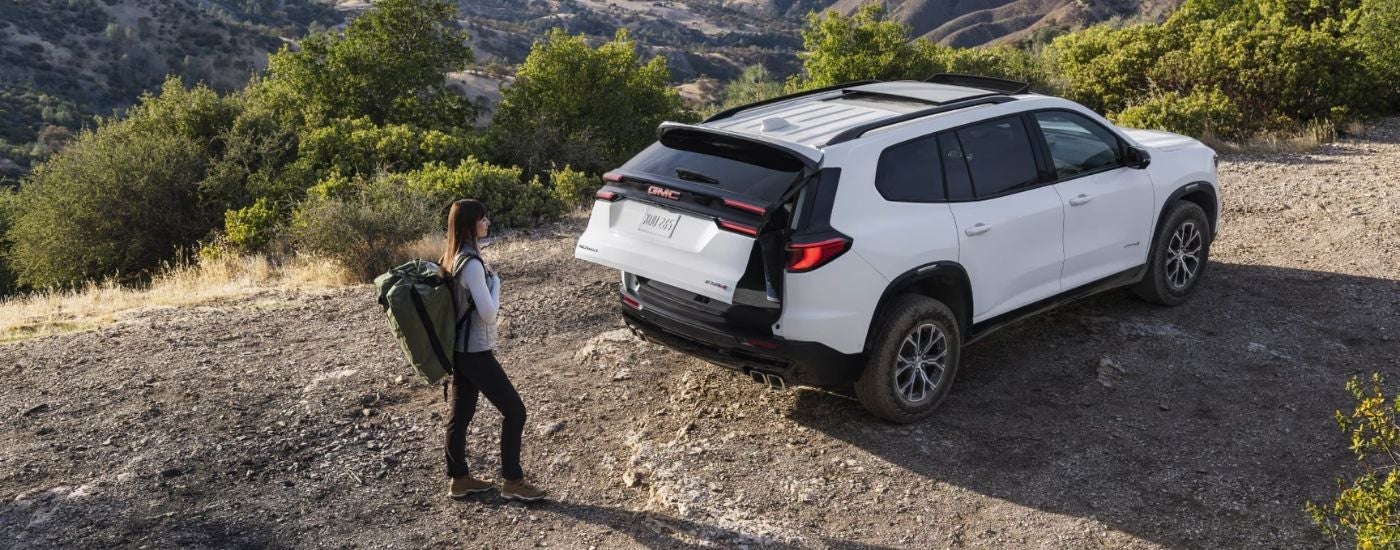 Rear gate opening on a white 2025 GMC Acadia AT4.