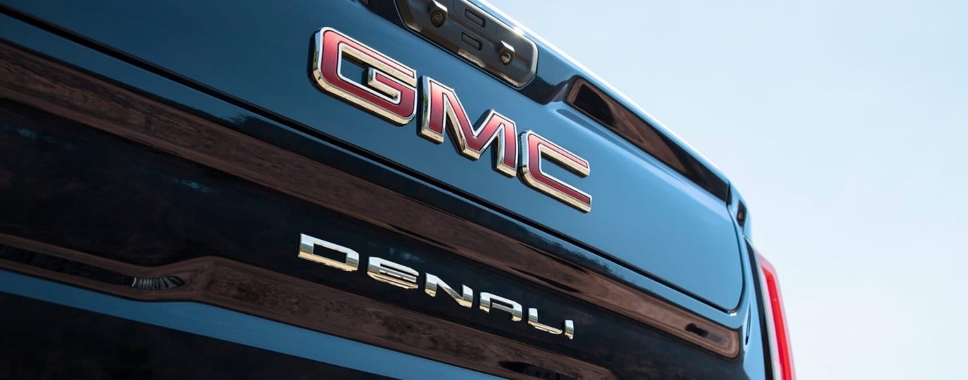 A close up shows the rear badging on a black 2023 GMC Sierra 1500 Denali.