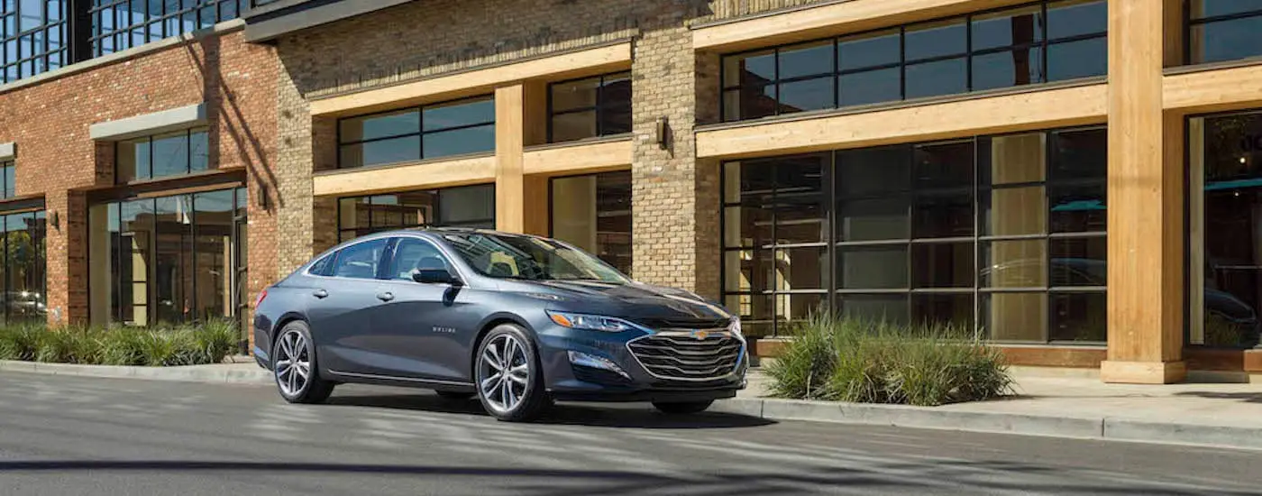 A grey 2021 Chevy Malibu is shown from the front at an angle.