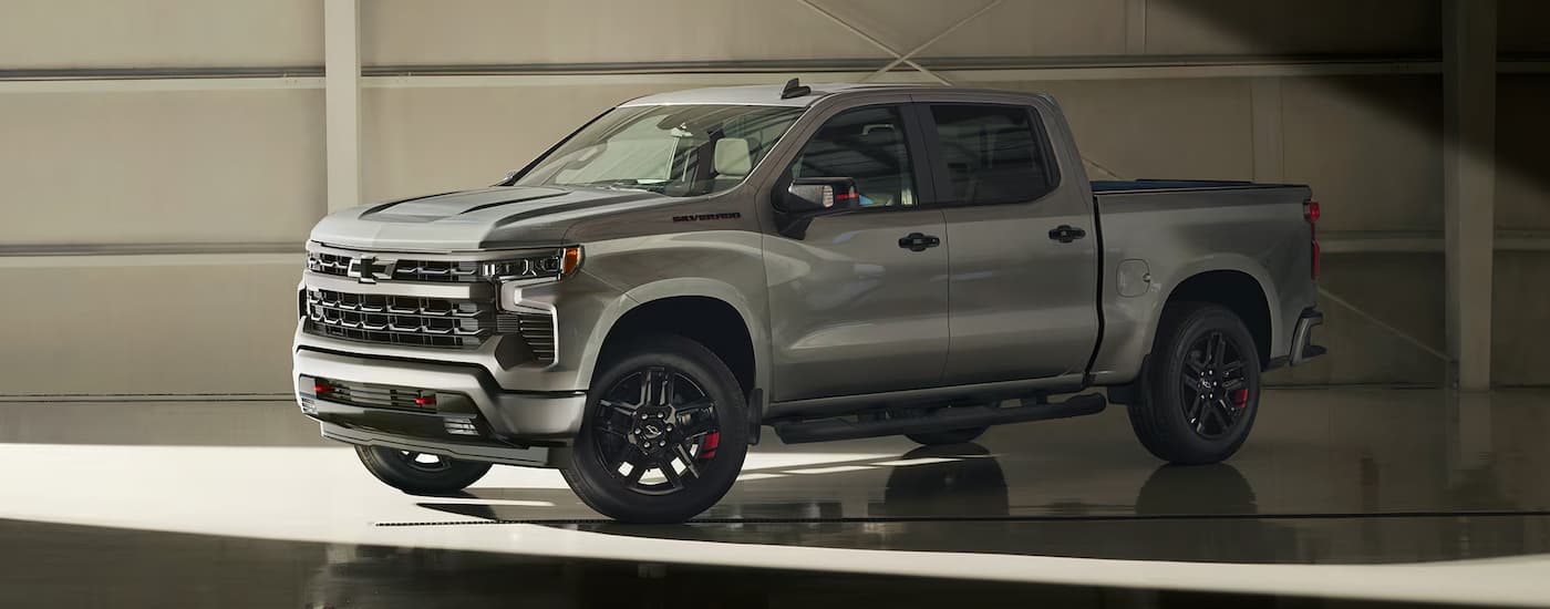 A silver 2024 Chevy Silverado 1500 RST Redline Edition parked in a garage.